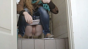 Young blondie pulls down her jeans and pisses in the toilet